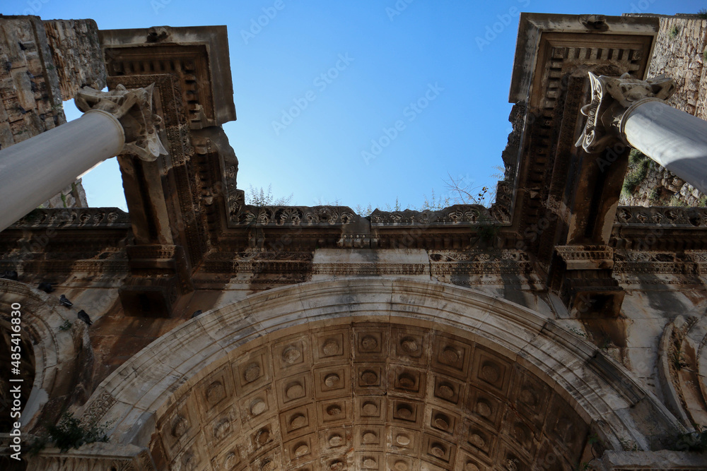 Hadrian's Gate - ancient triumphal arch located in Antalya, Turkey against blue sky