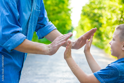A Hands of happy parent and child on nature on the road in park background