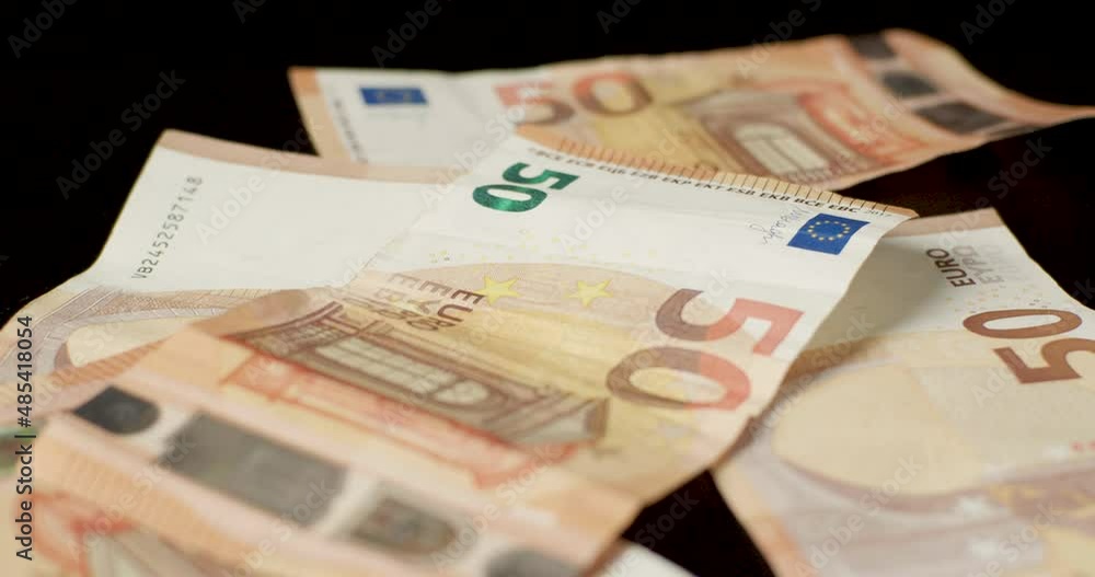 Billetes de euros cayendo sobre la mesa a cámara lenta. Dinero en efectivo y ganancias. Billetes de euros cayendo sobre la mesa a cámara lenta. Dinero en efectivo y ganancias.