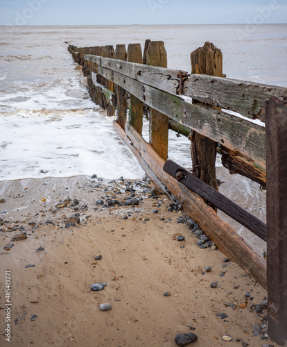 Wooden groynes to protect the fragile cliffs from coastal erosion on Cromer beach