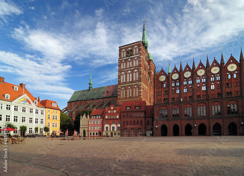 View From The Market Place Alter Markt To The Historic City Hall Of Stralsund Germany On A Beautiful Sunny Summer Day With A Clear Blue Sky And A Few Clouds