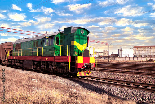Diesel locomotive railway on a background of blue sky with white clouds