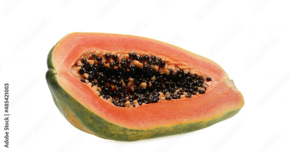 One-half of a papaya fruit rotating. Isolated on white background. One-half of a papaya fruit rotating. Isolated on white background.