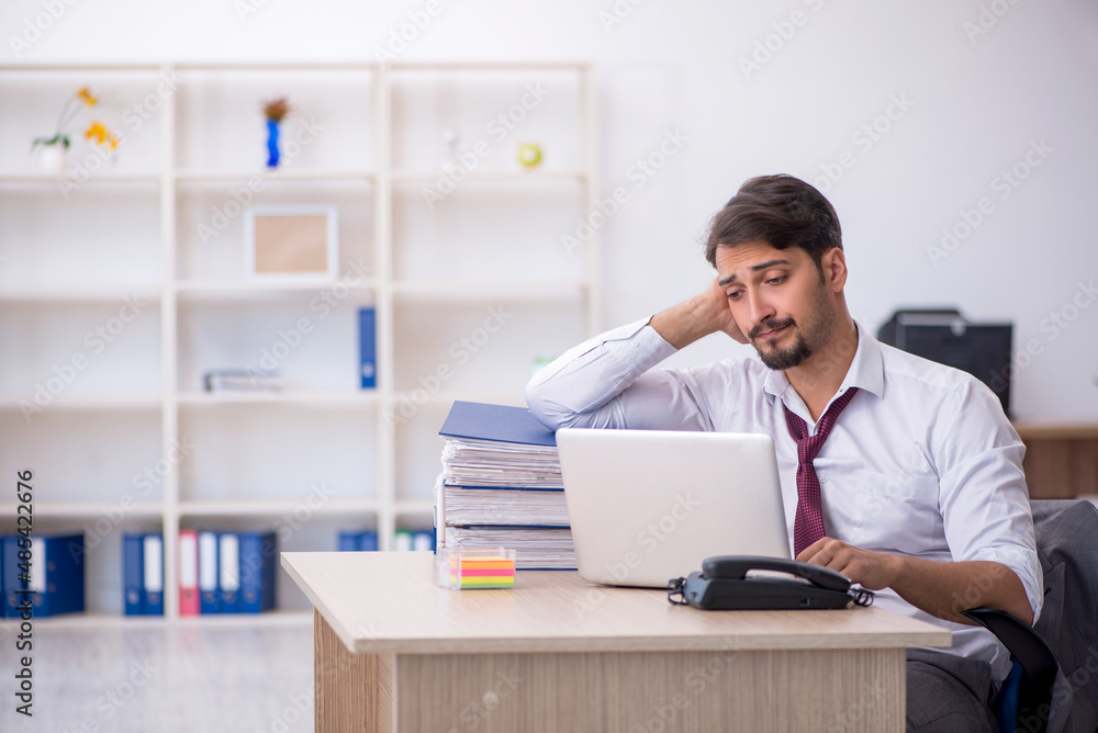 Young male employee working in the office