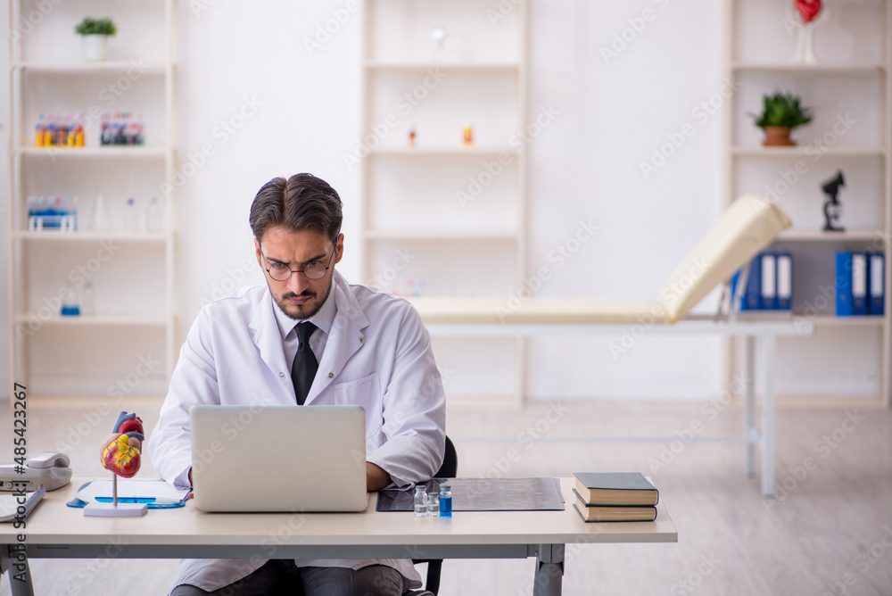 Young male doctor cardiologist working in the clinic Young male doctor cardiologist working in the clinic