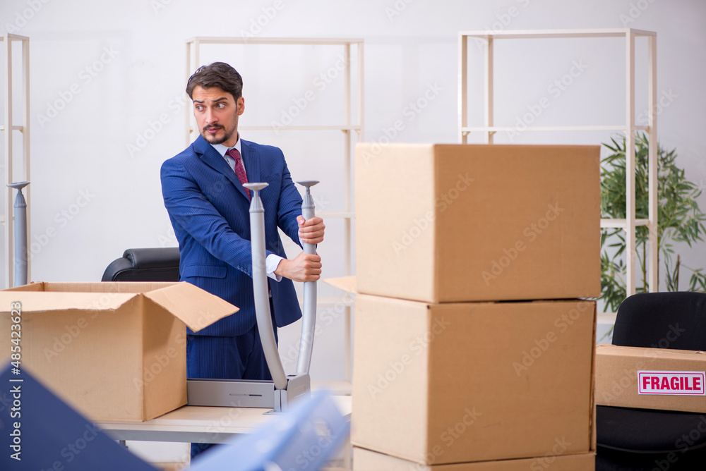 Young male employee in relocation concept Young male employee in relocation concept