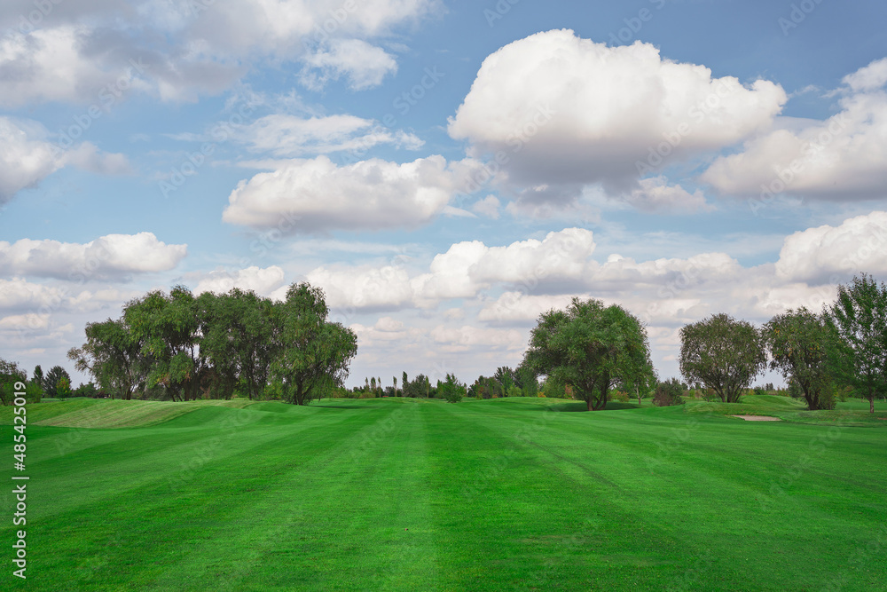 landscape. golf course and sky with clouds. lawn grass.