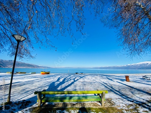 Ohrid lake, snow, sky and the town of Pogradec in Albania. photo