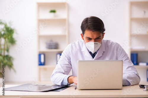Young male doctor in telemedicine concept during pandemic
