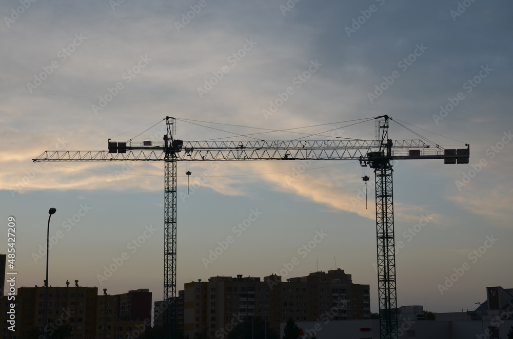 Construction machine. Construction Crane on a background of the sky. building.  Industrial construction cranes and building silhouettes 