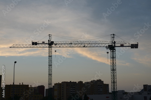 Construction machine. Construction Crane on a background of the sky. building. Industrial construction cranes and building silhouettes 