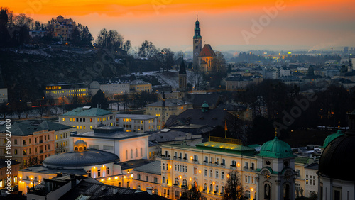 Salzburg at sunset. Mountains, winter holidays in Austria. Historic buildings, city center. Salzburg State Theatre, Mullnertor Stadttor
