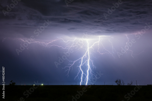 Real lightning. Two cloud to ground lightning bolts strike inside a thunderstorm in New Mexico