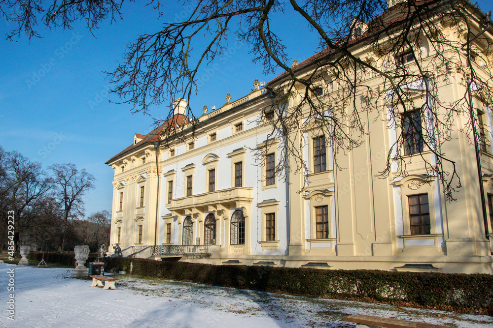 Slavkov Castle in the Czech Republic illuminated by the sun in winter. Snow lies in the park and garden in front of the castle. Slavkov Castle in the Czech Republic illuminated by the sun in winter. Snow lies in the park and garden in front of the castle.