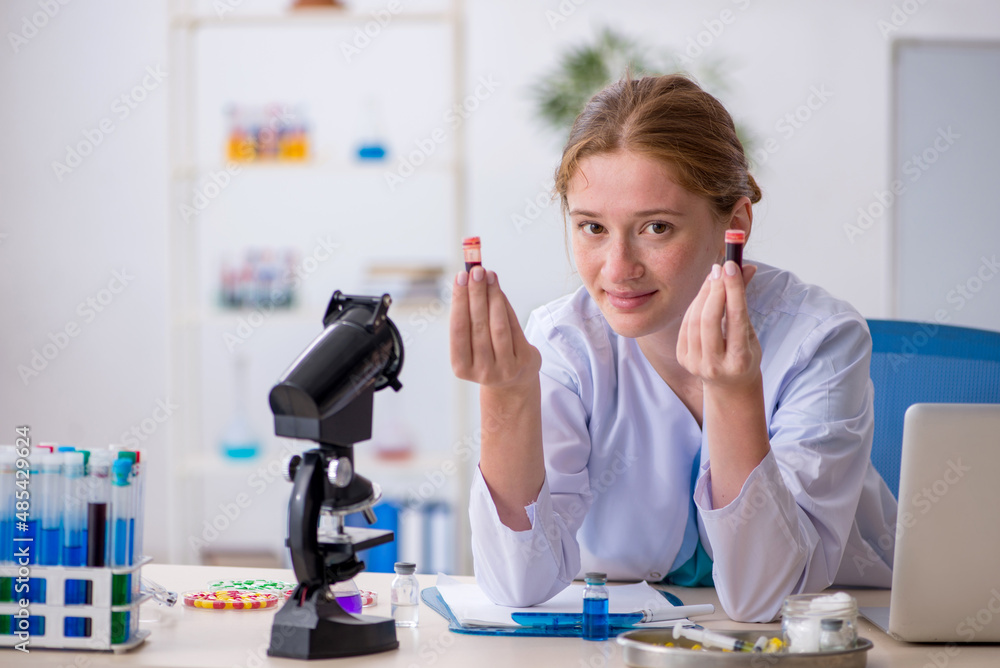 Young female chemist in drugs synthesis concept