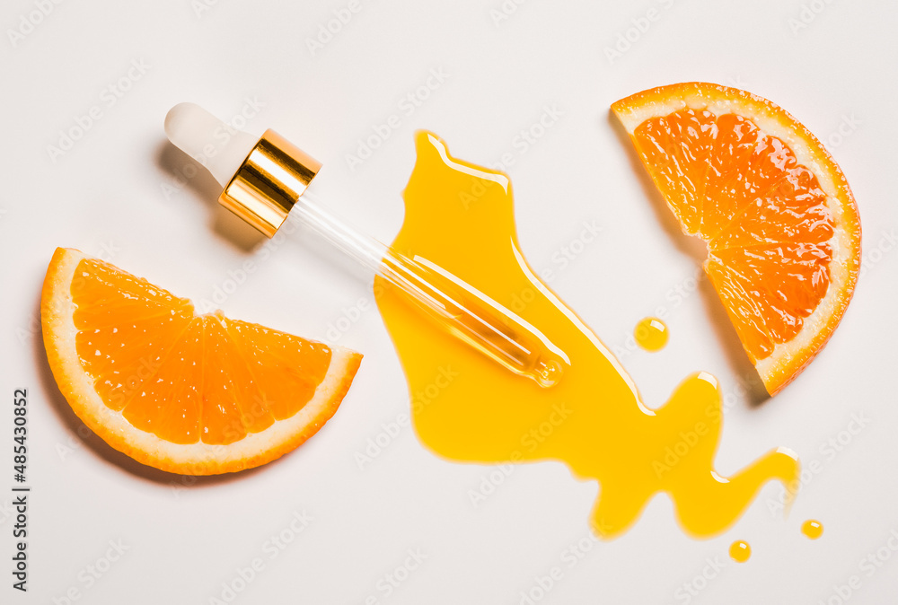 Serum oil vitamin C pipette and drops on white background copy space skin care beauty product. Anti aging antioxidant beauty serum vitamin C oil natural cosmetic.