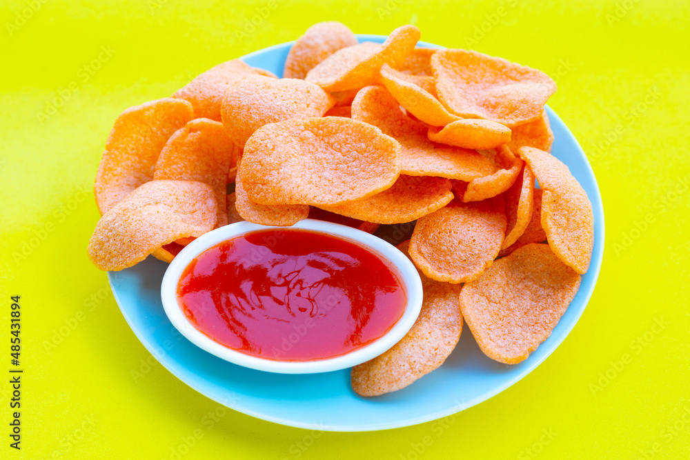 Prawn crackers on green background. Shrimp crispy rice snack Prawn crackers on green background. Shrimp crispy rice snack