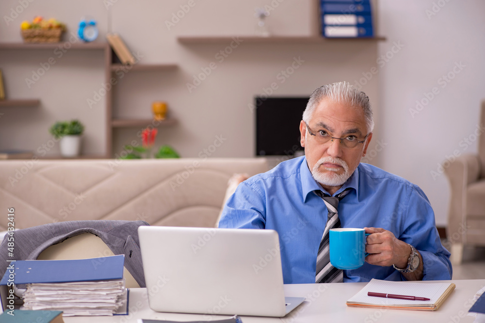 Old male employee working from home during pandemic Old male employee working from home during pandemic