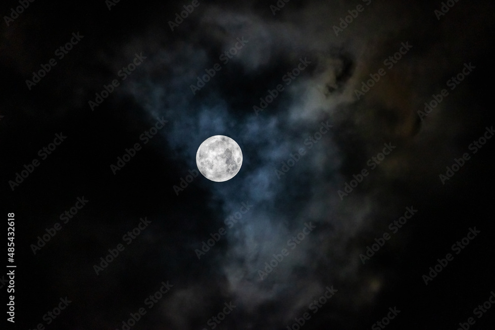 Full moon in the night sky among the clouds Full moon in the night sky among the clouds