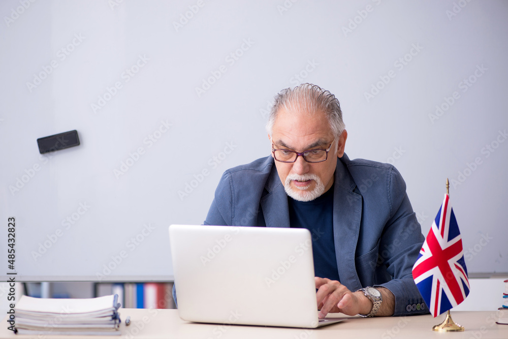 Old male english language teacher in the classroom Old male english language teacher in the classroom