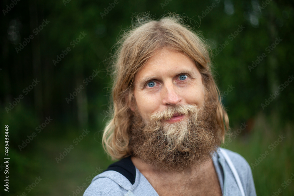 Guy with thick unshaved beard. Young man in white hoodie. Man in nature. Guy with thick unshaved beard. Young man in white hoodie. Man in nature.
