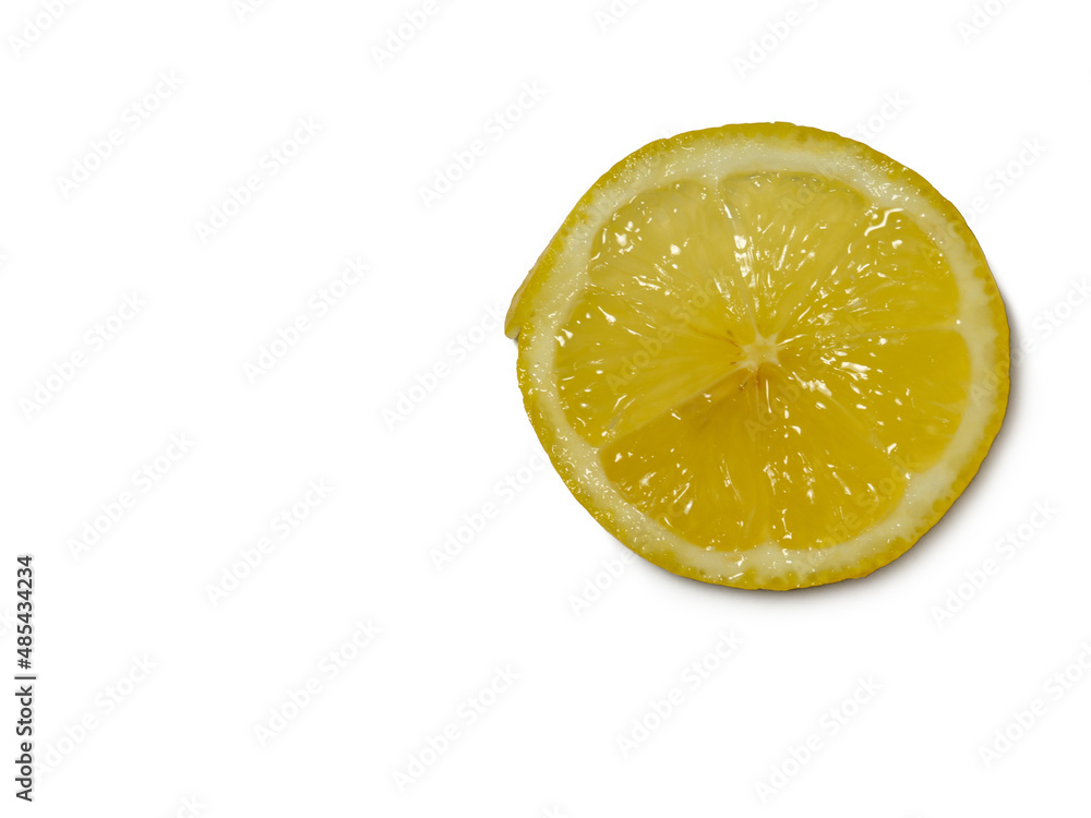 A sliced lemon on a white background. Citrus on the table. Bright background. Healthy fortified food for a diet. A sliced lemon on a white background. Citrus on the table. Bright background. Healthy fortified food for a diet.