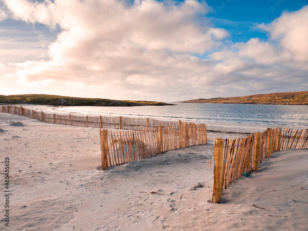 Entrance to the beach through wooden fence on sand dune. Dog's bay, county Galway, Ireland. Beautiful Irish scenery. Popular travel area. Sunset time