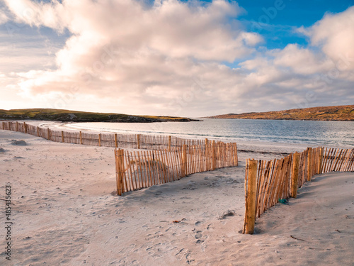 Entrance to the beach through wooden fence on sand dune. Dog's bay, county Galway, Ireland. Beautiful Irish scenery. Popular travel area. Sunset time