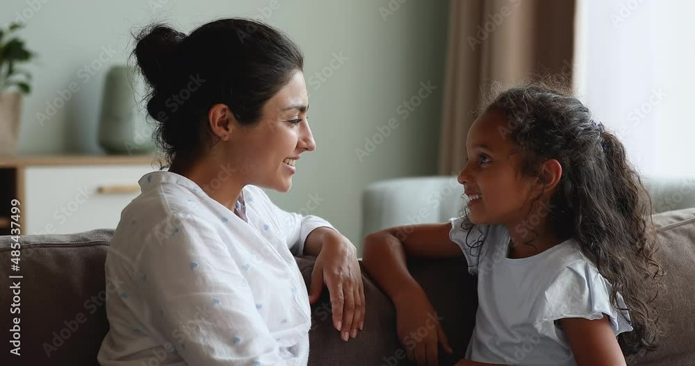 Caring Indian mother teach her little 6s daughter to pronounce words correctly. Professional speech-language pathologists therapist teach preschool girl with speech disorder. Kid development concept Caring Indian mother teach her little 6s daughter to pronounce words correctly. Professional speech-language pathologists therapist teach preschool girl with speech disorder. Kid development concept