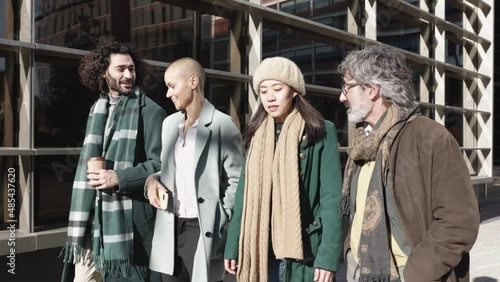 Wallpaper Mural Group of four diverse business people talking and walking in financial district in city street - Leadership and teamwork corporate concept Torontodigital.ca
