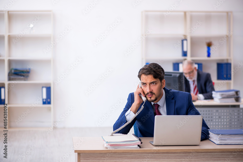 Two male colleagues working in the office Two male colleagues working in the office