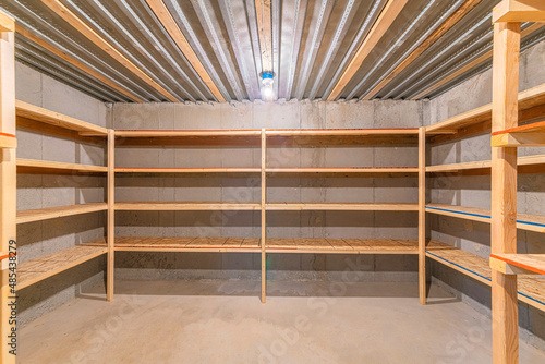 Unfinished food storage at the basement with concrete walls