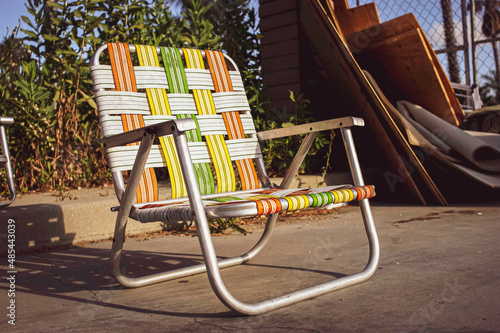 Colorful retro lawn chairs on concrete during summer photo