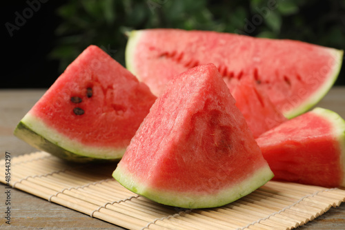 Slices of tasty ripe watermelon on wooden table, closeup