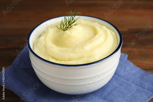 Freshly cooked homemade mashed potatoes with napkin on wooden table, closeup