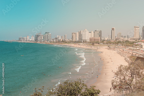 Coastline of city Tel Aviv in Israel with beach and sea on sunny summer day.