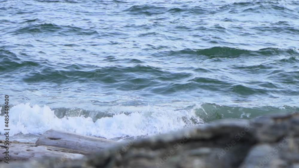 Close-Up Shot From The Beach To The Sea Waves with Wood Logs in Slow Motion. Close-Up Shot From The Beach To The Sea Waves with Wood Logs in Slow Motion.