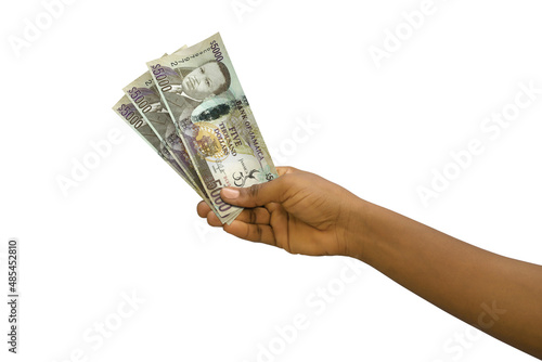 Fair hand holding 3D rendered Jamaican dollar notes isolated on white background