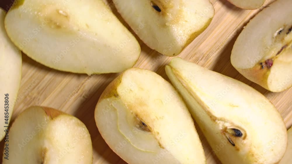 Sliced pears rotation on a wood cutting board. Loop motion Sliced pears rotation on a wood cutting board. Loop motion
