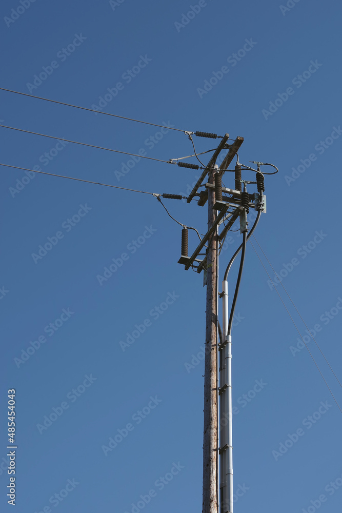 Electricity distribution pylon and power lines under blue sky Electricity distribution pylon and power lines under blue sky