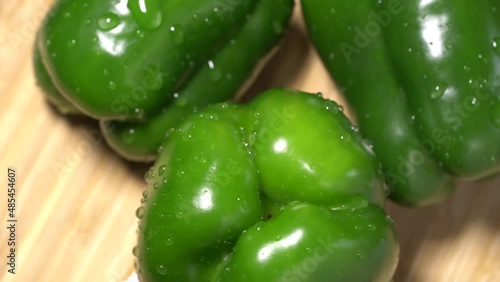 Fresh wet green bell peppers close up rotation