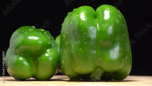 Fresh wet green bell peppers close up rotation
