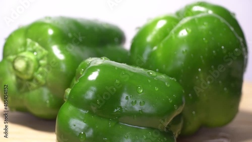 Fresh wet green bell peppers close up rotation