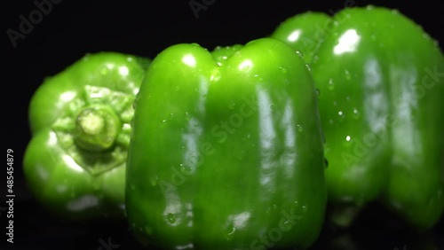 Fresh wet green bell peppers close up rotation