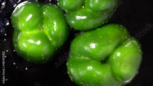 Fresh wet green bell peppers close up rotation