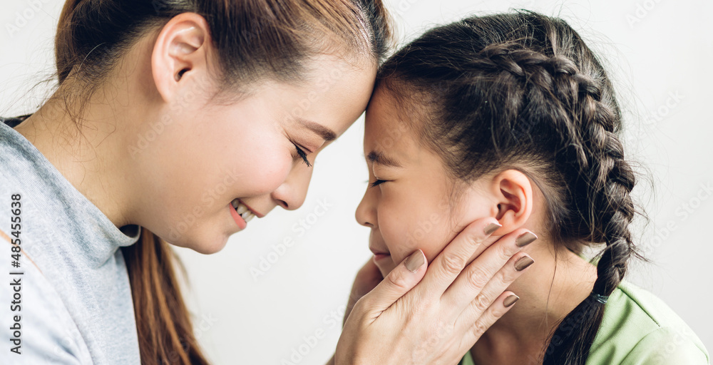 Portrait of enjoy happy love asian family mother and little asian girls child smiling and having fun touching face with cute kid daughter moments good time Portrait of enjoy happy love asian family mother and little asian girls child smiling and having fun touching face with cute kid daughter moments good time