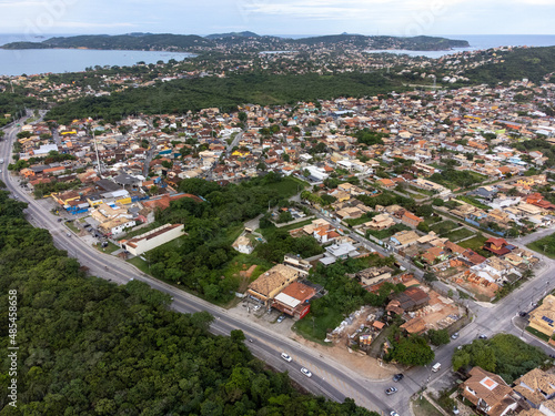 Amazing seaside town amidst nature and mountains top view  drone - Arma    o de B  zios  Rio de Janeiro  Brazil