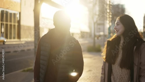 Content multiracial friends walking along street