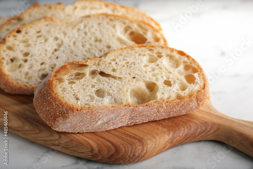 Freshly baked sodawater bread on wooden board, closeup photo