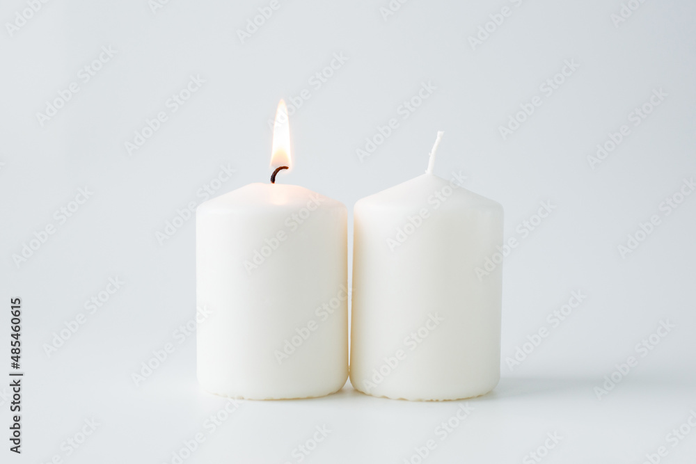 Two candles on a light background Two candles on a light background